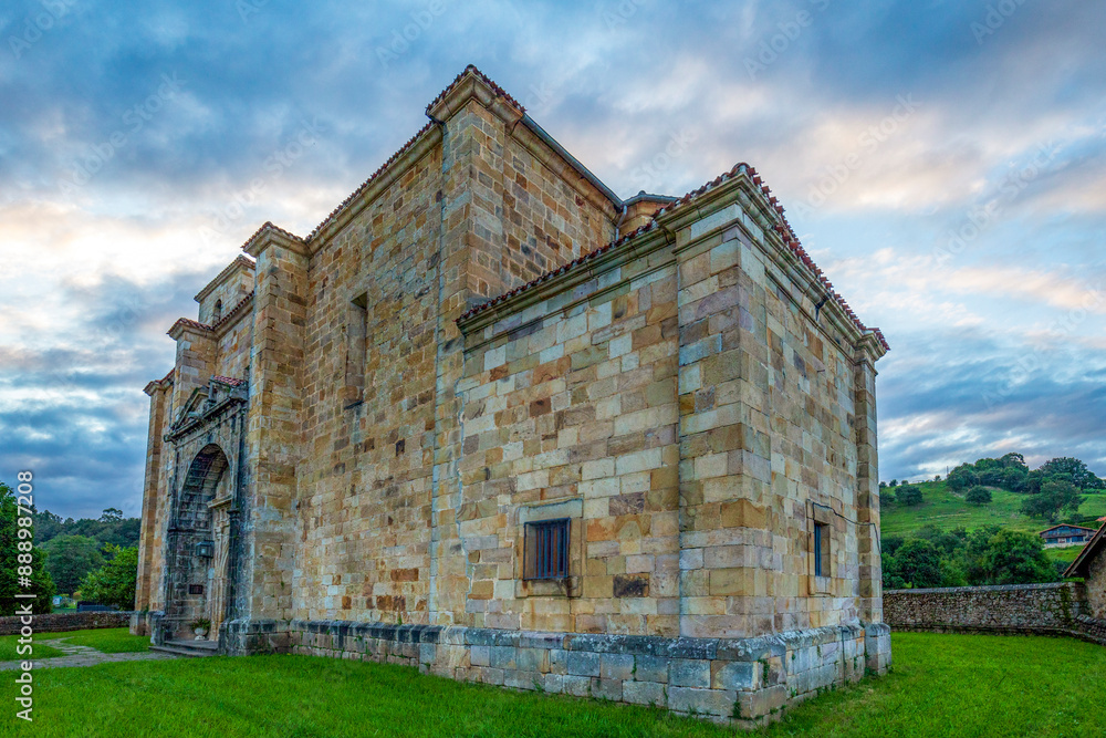 Fototapeta premium View from the rear and perspective of the church of San Pedro ad Vincula in Liérganes, Cantabria, Spain, Renaissance style and colorful sky at sunset