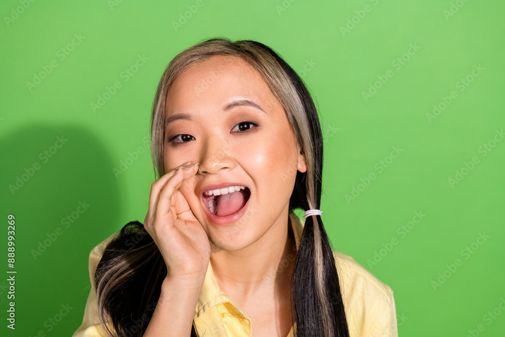Portrait of pretty young girl speak whisper wear yellow jacket isolated on green color background Portrait of pretty young girl speak whisper wear yellow jacket isolated on green color background