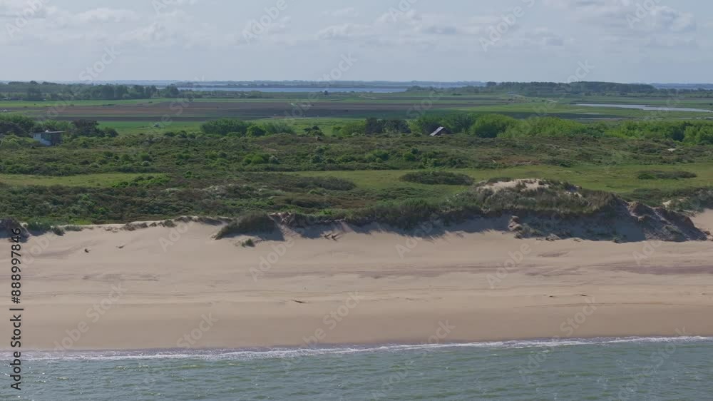 Aerial view of tranquil beach, lighthouse, and dunes at Westhoofd, Ouddorp, Netherlands. Aerial view of tranquil beach, lighthouse, and dunes at Westhoofd, Ouddorp, Netherlands.