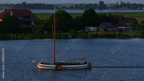 Aerial view of tranquil lake with picturesque village and serene sunset, Sandfirden, Friesland, Netherlands. photo