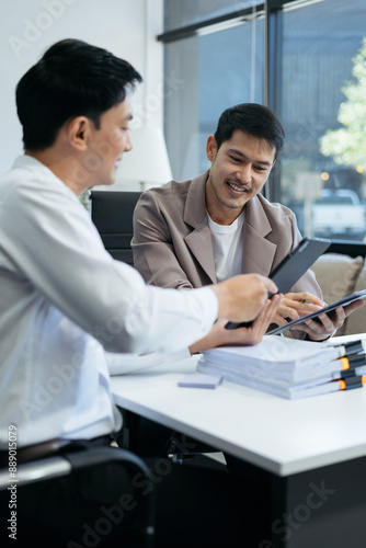 Wallpaper Mural Business team working on a project in the office or reviewing and discussing a business project. Torontodigital.ca