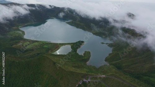 Aerial view of Langisfor Lake surrounded by lush greenery and mist, Sao Miguel, Azores, Portugal. photo