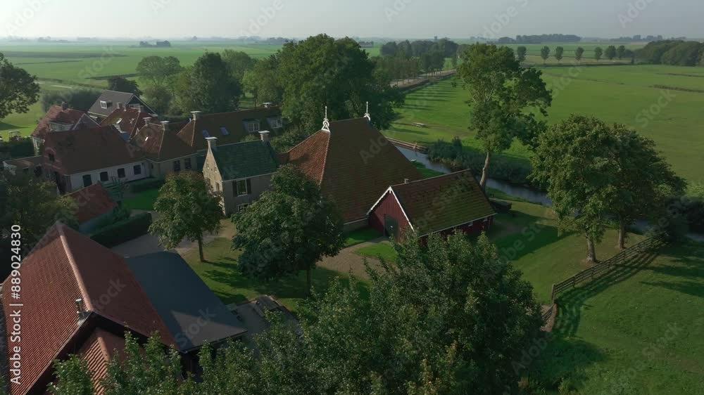 Aerial view of peaceful village with church, farm, and river, Allingawier, Friesland, Netherlands. Aerial view of peaceful village with church, farm, and river, Allingawier, Friesland, Netherlands.