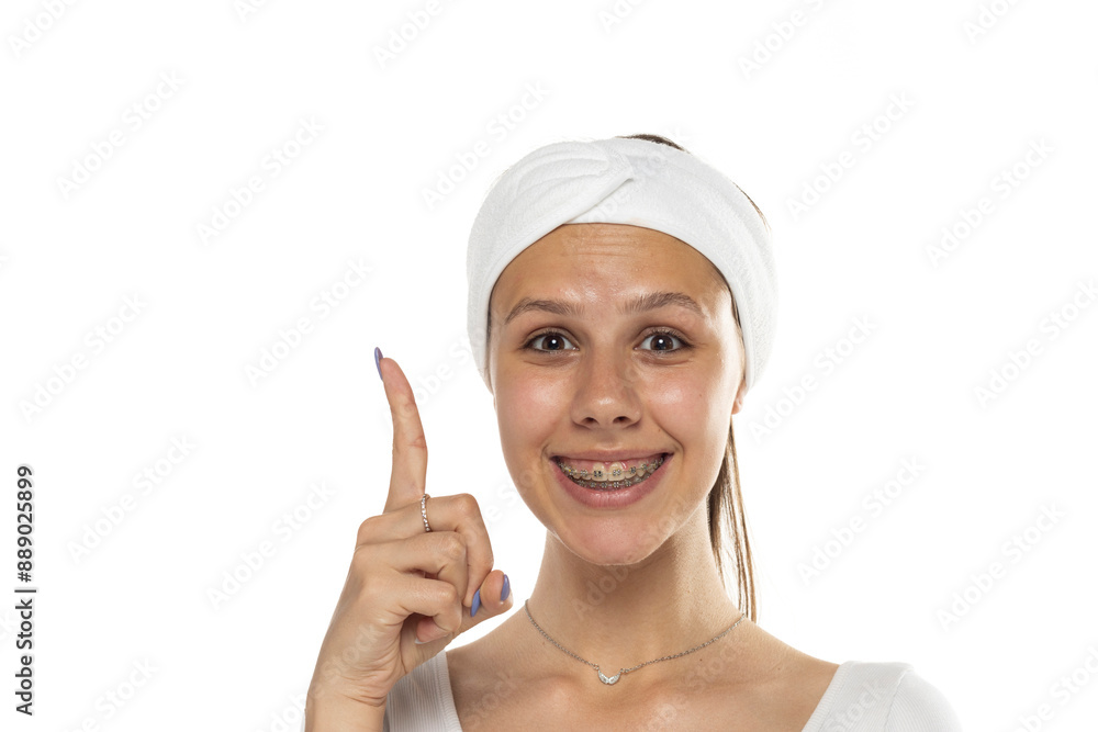 Portrait of young adult woman pointing up with index finger. Isolated on white background. Portrait of young adult woman pointing up with index finger. Isolated on white background.