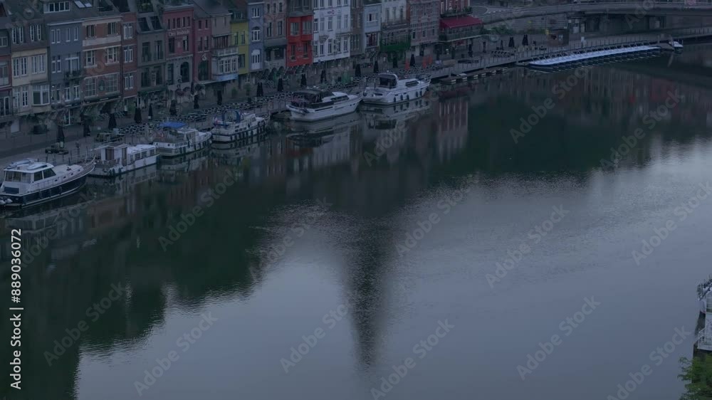 Aerial view of historic town with river, boats, and church in foggy sunrise, Dinant, Belgium. Aerial view of historic town with river, boats, and church in foggy sunrise, Dinant, Belgium.