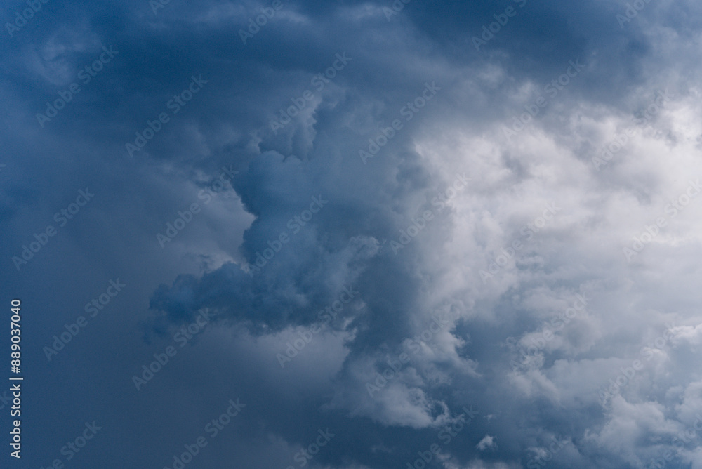 Dramatic view of dark storm clouds forming in the sky, indicating an impending storm with contrasting shades of blue and gray. Dramatic view of dark storm clouds forming in the sky, indicating an impending storm with contrasting shades of blue and gray.