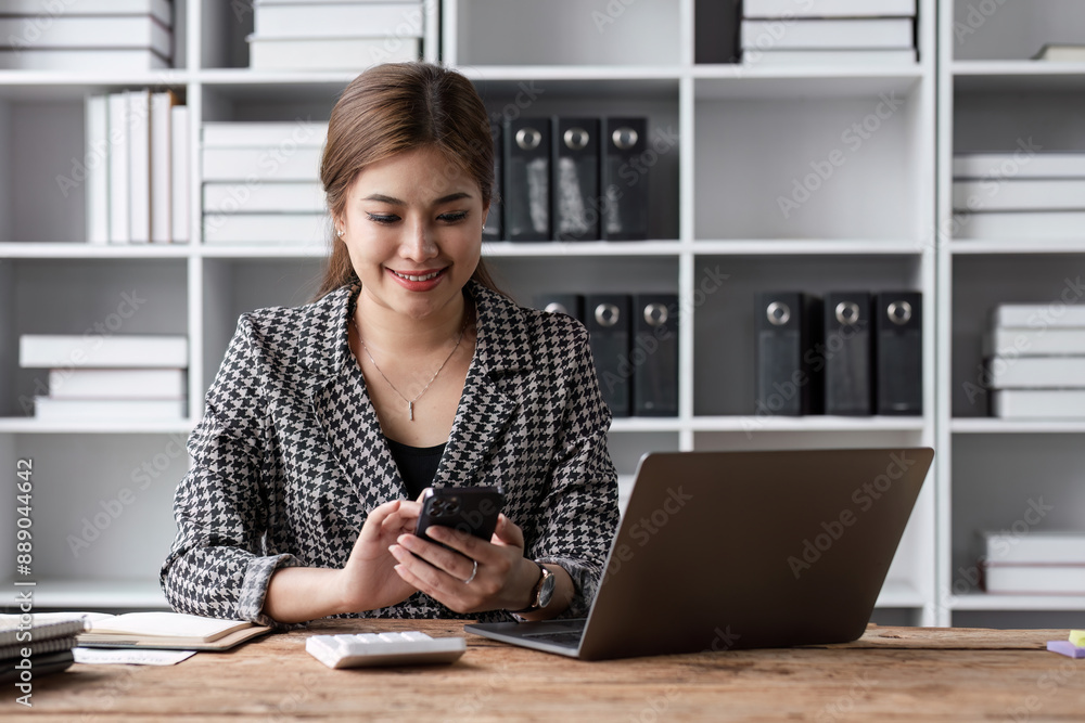 Young Accountant Working on Financial Document at Modern Office Desk with Laptop and Calculator Young Accountant Working on Financial Document at Modern Office Desk with Laptop and Calculator