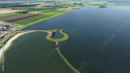 Aerial view of Tulpeiland shape surrounded by Wolderwijd lake and wind turbines, Zeewolde, Flevoland, Netherlands. photo