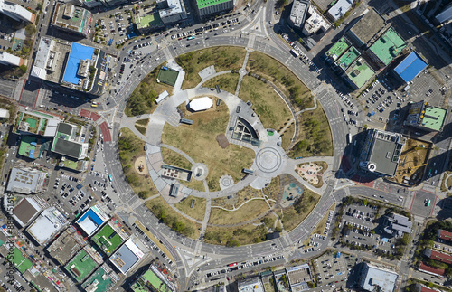 Danwon-gu, Ansan-si, Gyeonggi-do, South Korea - April 8, 2023: Aerial and top angle view of road and rotary with trail and trees surrounded by villas and apartments
 photo