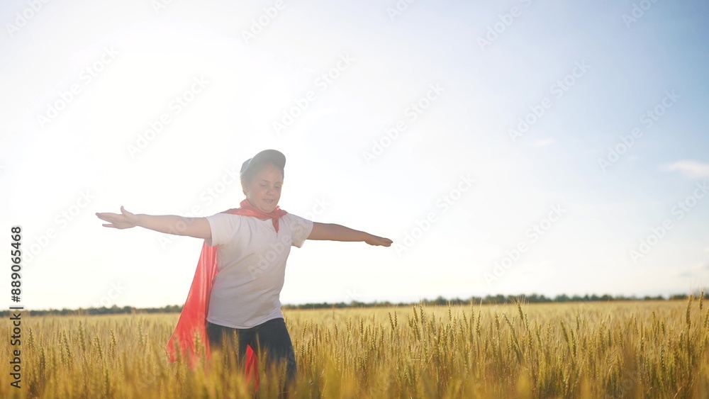 Superhero running through the wheat with his child. Hero super costume concept. girl runs across a field of wheat with a superhero. Girl runs through a field of fun wheat and runs into a superhero. Superhero running through the wheat with his child. Hero super costume concept. girl runs across a field of wheat with a superhero. Girl runs through a field of fun wheat and runs into a superhero.