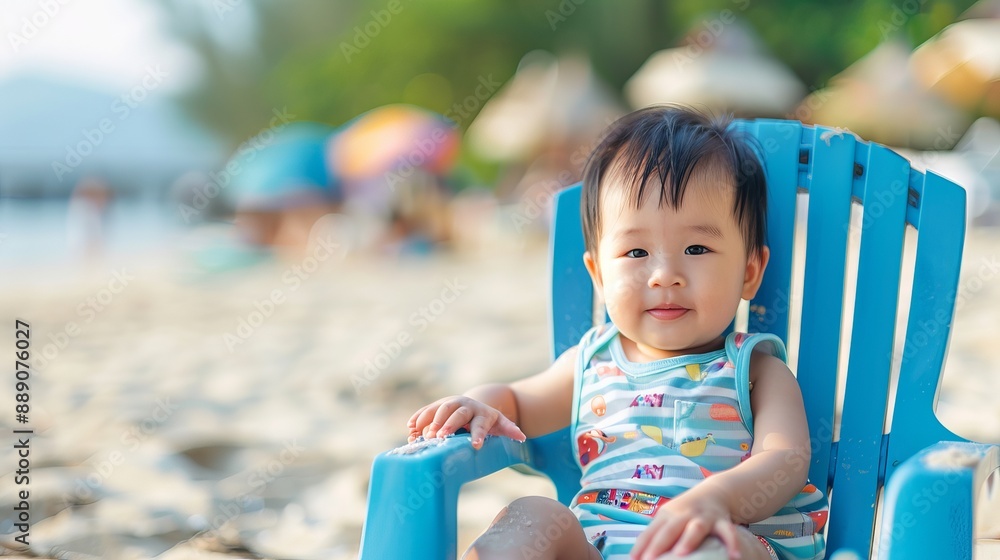 Cute Asian baby boy wearing summer clothes, sitting on a beach chair. Cute Asian baby boy wearing summer clothes, sitting on a beach chair.