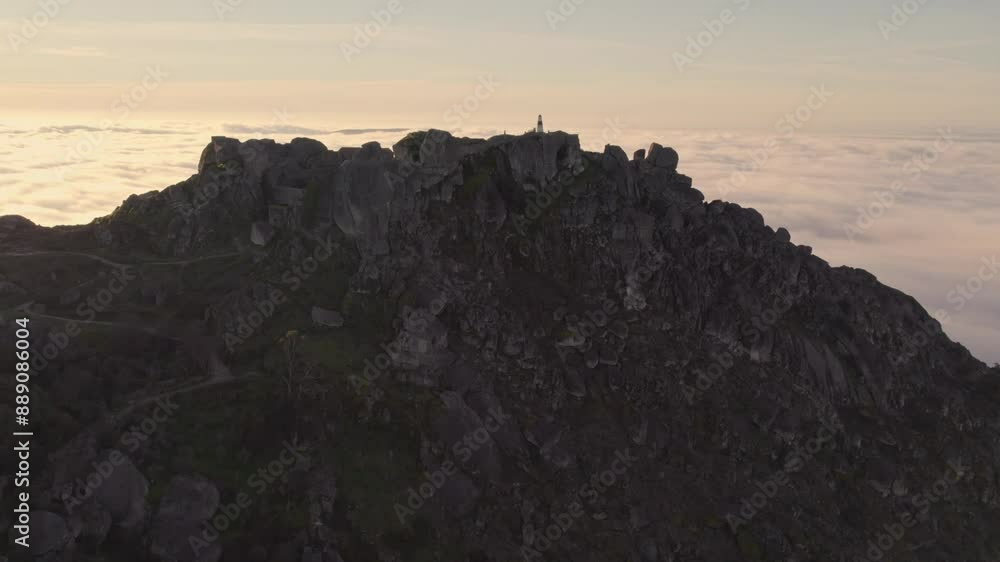 Aerial view of majestic castle ruins surrounded by rugged mountains and dramatic clouds, Monsanto, Castelo Branco, Portugal. Aerial view of majestic castle ruins surrounded by rugged mountains and dramatic clouds, Monsanto, Castelo Branco, Portugal.