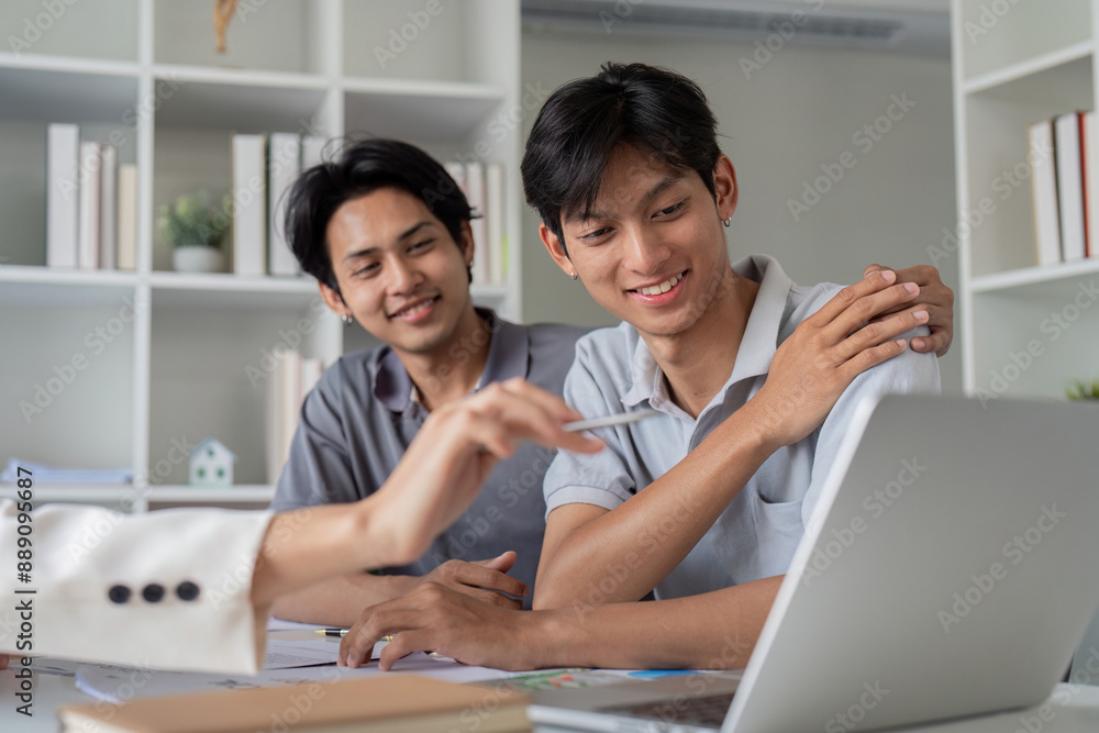 Gay Couple Planning Finances Together at Home with Laptop and Documents, Discussing Future Investments and Budgeting Gay Couple Planning Finances Together at Home with Laptop and Documents, Discussing Future Investments and Budgeting