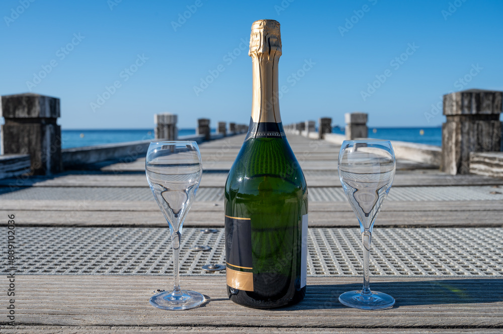 Summer time in Provence, two glasses of cold champagne cremant sparkling wine on famous Pampelonne sandy beach near Saint-Tropez in sunny day, Var department, France, beach club party Summer time in Provence, two glasses of cold champagne cremant sparkling wine on famous Pampelonne sandy beach near Saint-Tropez in sunny day, Var department, France, beach club party