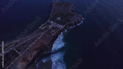 Aerial view of Fortress overlooking ocean waves at sunset, Sagres, Portugal. photo