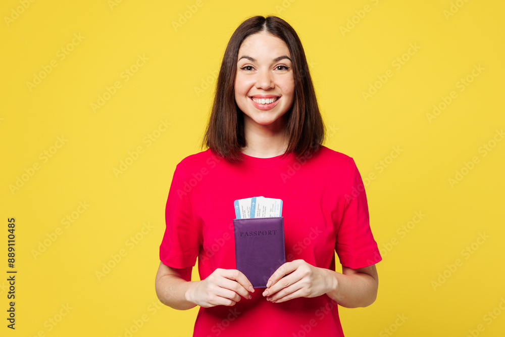 Traveler happy woman wear pink casual clothes hold passport ticket isolated on plain yellow background studio. Tourist travel abroad in free spare time rest getaway. Air flight trip journey concept. Traveler happy woman wear pink casual clothes hold passport ticket isolated on plain yellow background studio. Tourist travel abroad in free spare time rest getaway. Air flight trip journey concept.