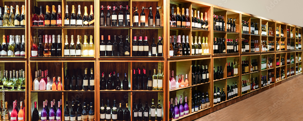 Wine store with wooden shelves full of bottles of wine and champagne. Wine store with wooden shelves full of bottles of wine and champagne.