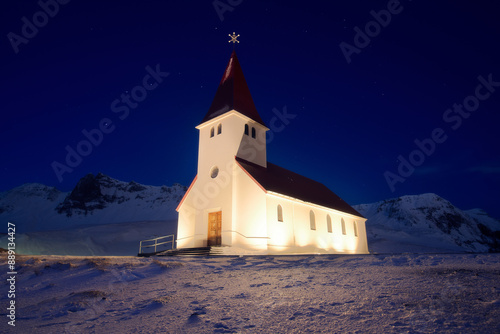 Majestic church Reynisfjara during winter night in town of Vik in south Iceland, architectural panorama of beautiful small church photo