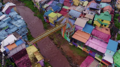 Aerial view of colorful houses, bridge, and river in Jodipan, rainbow village, Malang City, East Java, Indonesia. photo