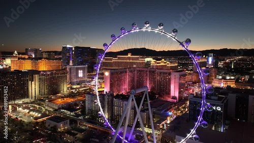 Ferris Wheel At Las Vegas Nevada United States. Aerial View Of A High-Rise Buildings And Traffic In Las Vegas City. Sunset Sky Background Downtown Cityscape. Sunset Drone View Panoramic.