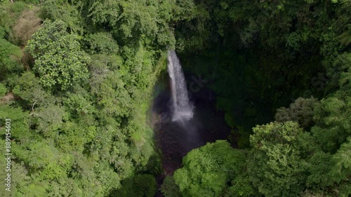 Aerial view of lush jungle with Nungnung waterfall and winding river, Badung, Bali, Indonesia. photo