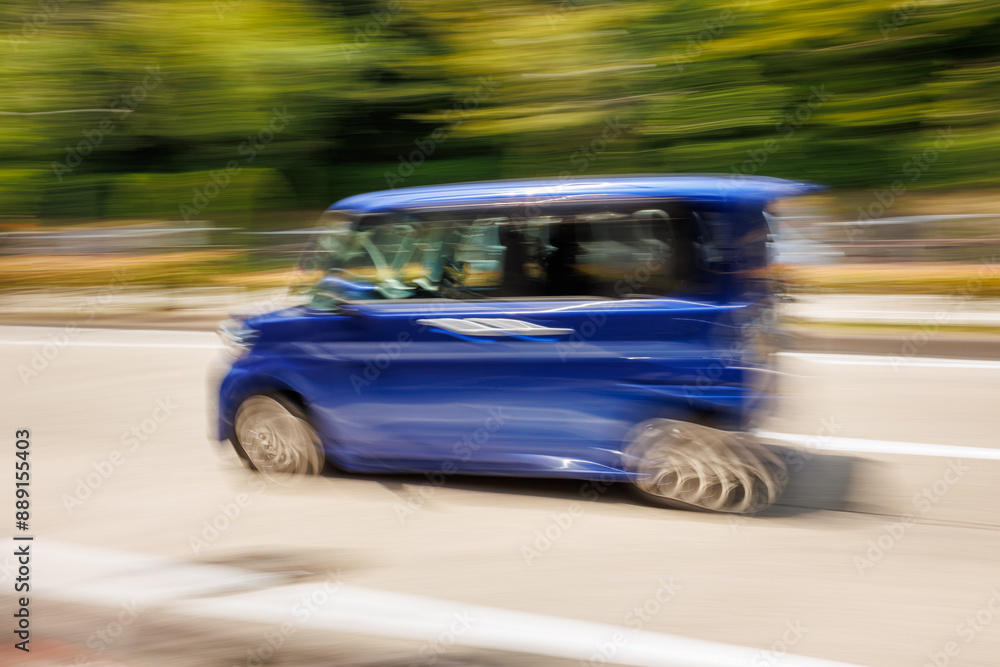 Motion Blur Photo of Speeding Blue Japanese Mini Car in Motion Motion Blur Photo of Speeding Blue Japanese Mini Car in Motion