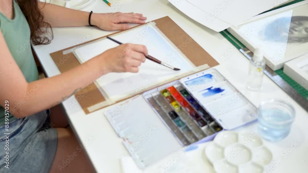 Woman artist working on her latest creation in the studio Woman artist working on her latest creation in the studio