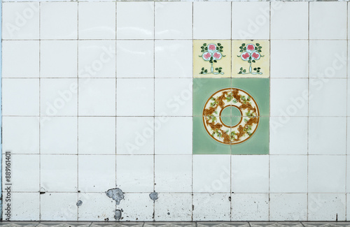 Antique Nyonya Tiles with red roses on yellow base on white tiles background. Traditional Peranakan cultural in Malaysia. Vintage Baba & Nyonya style floral tile pattern