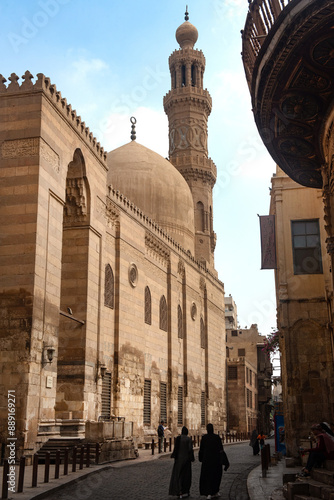 .Locals and tourists walk  past one of the many restored monuments along Sharia Al Muizz Li Din Allah near Khan El Khalili Bazaar, historical Cairo, Egypt. photo