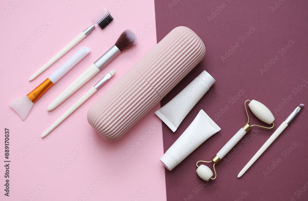 Organizer case with makeup accessories on a pink burgundy background Organizer case with makeup accessories on a pink burgundy background