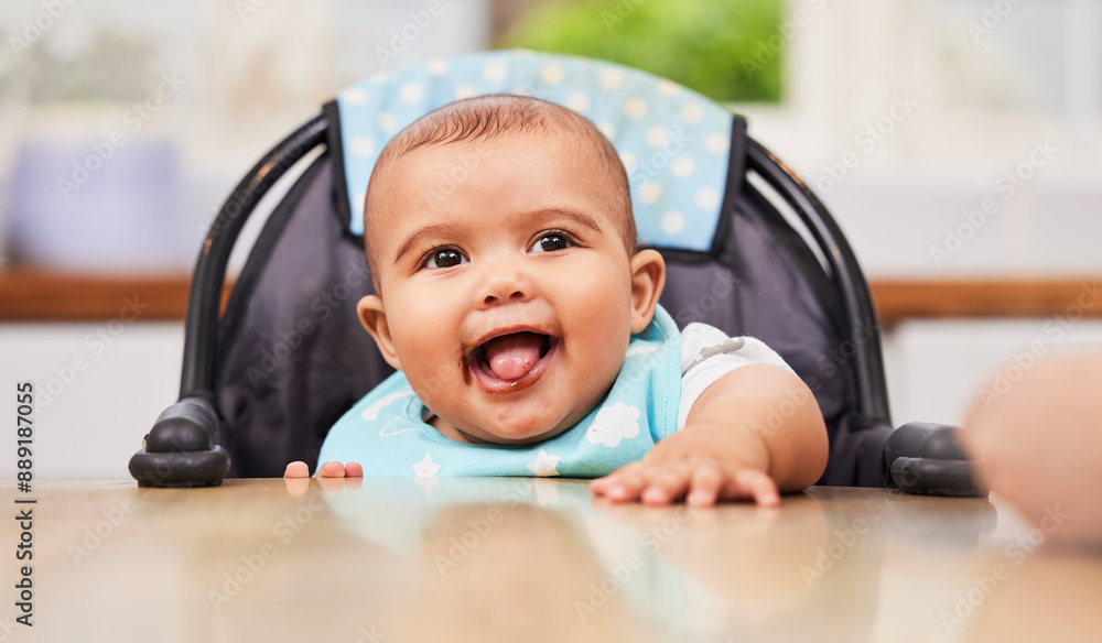 Baby, boy and eating in kitchen for nutrition, happiness and messy mouth for growth development. Male person, infant and high chair for wellness in meal, breakfast and morning for learning in home Baby, boy and eating in kitchen for nutrition, happiness and messy mouth for growth development. Male person, infant and high chair for wellness in meal, breakfast and morning for learning in home