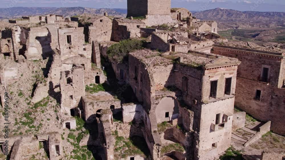 Aerial view of abandoned town of Craco with ruins, hill, and countryside, Matera, Italy. Aerial view of abandoned town of Craco with ruins, hill, and countryside, Matera, Italy.