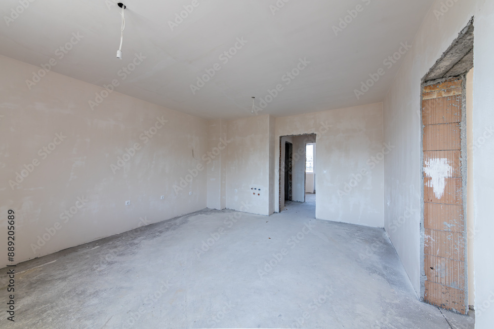 New empty room under construction. Plaster walls. New home. Concrete walls. Interior renovation. New empty room under construction. Plaster walls. New home. Concrete walls. Interior renovation.