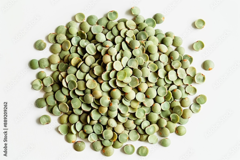 A pile of fresh green peas arranged on a clean white surface A pile of fresh green peas arranged on a clean white surface