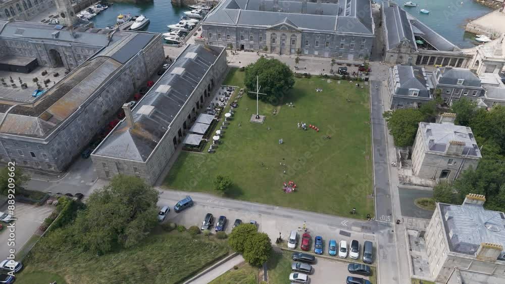 Aerial view of the pavilion at Royal William Yard in Plymouth, UK, featuring green space and marina Aerial view of the pavilion at Royal William Yard in Plymouth, UK, featuring green space and marina