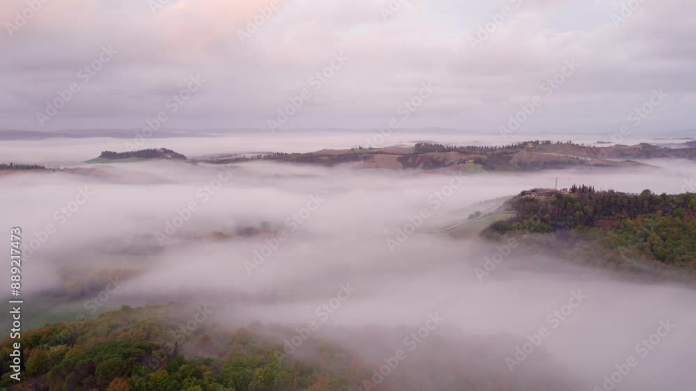 Aerial view of foggy countryside with villa, cypress trees, and winding road, Asciano, Tuscany, Italy. Aerial view of foggy countryside with villa, cypress trees, and winding road, Asciano, Tuscany, Italy.