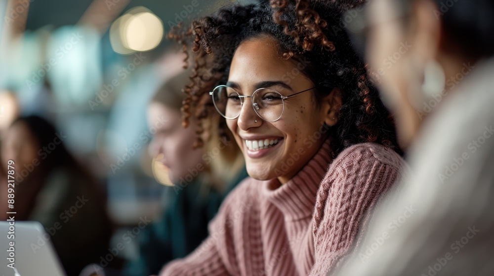 A woman with curly hair and glasses is shown laughing with friends, embodying the essence of joy, friendship, and the vibrancy of social connections in a lively setting. A woman with curly hair and glasses is shown laughing with friends, embodying the essence of joy, friendship, and the vibrancy of social connections in a lively setting.