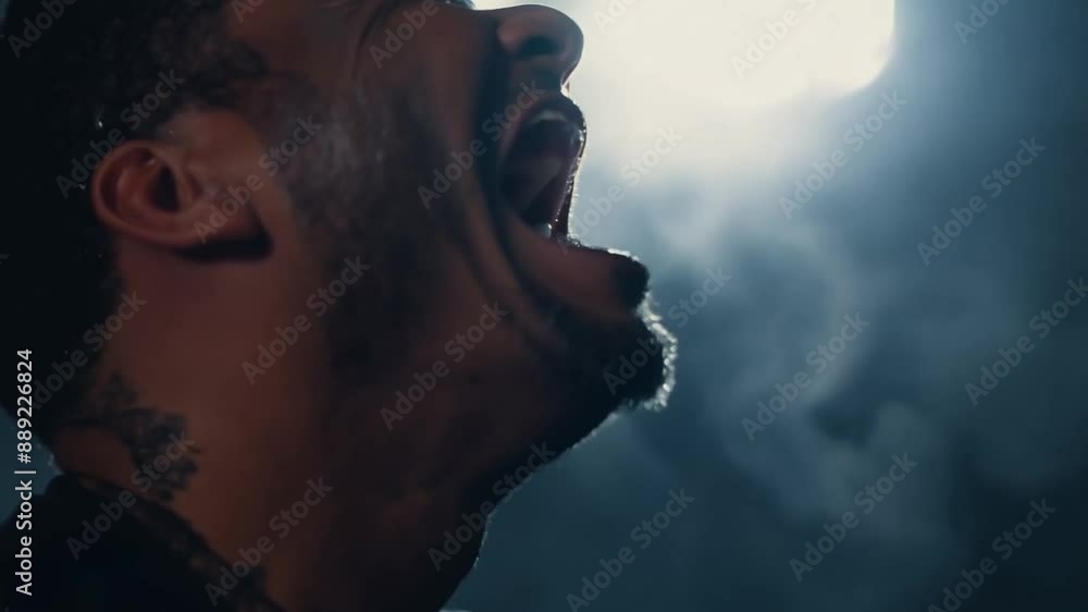 This man with a tattoo yells with a wide-open mouth. Emotion despair This man with a tattoo yells with a wide-open mouth. Emotion despair