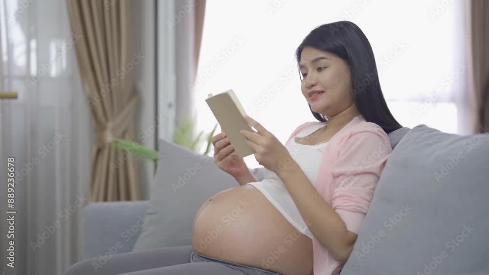 A Portrait of happy Asian pregnant woman in bedroom at home. Having a baby. Family people lifestyle. Love. A Portrait of happy Asian pregnant woman in bedroom at home. Having a baby. Family people lifestyle. Love.