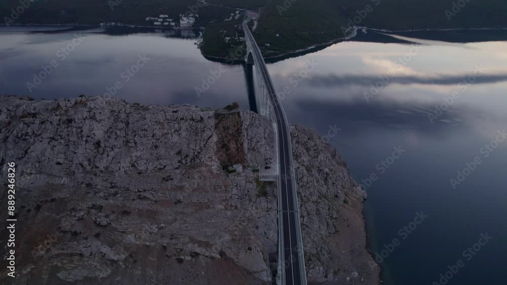 Aerial view of tranquil sunrise over bridge and rocky coast, Krk, Croatia. Aerial view of tranquil sunrise over bridge and rocky coast, Krk, Croatia.
