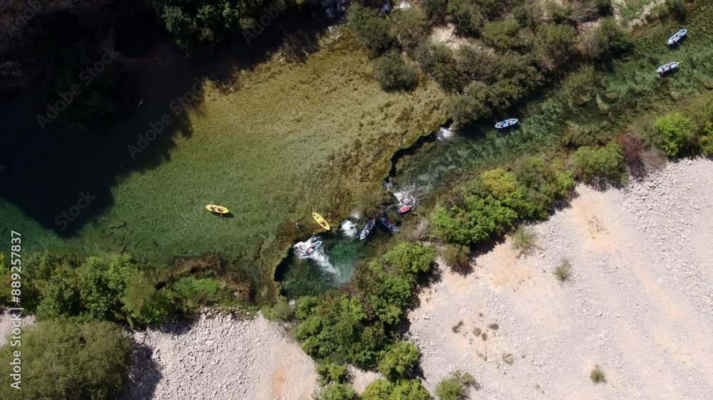 Aerial view of river, waterfall, kayak, canoe, boat, group, trees, and mountain, Zrmanja, Croatia. Aerial view of river, waterfall, kayak, canoe, boat, group, trees, and mountain, Zrmanja, Croatia.