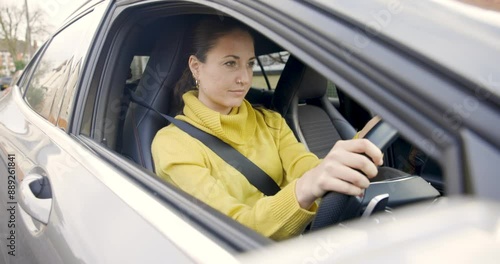 Authentic shot of smiling woman at the wheel in the car waiting to leave