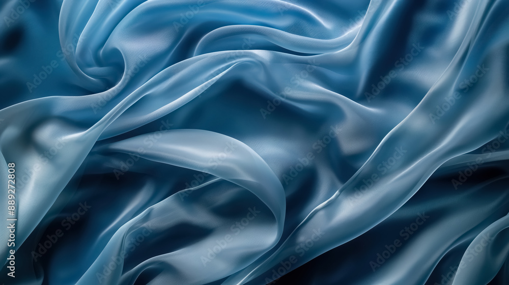 Light blue silk fabric draped gracefully against a dark blue backdrop Light blue silk fabric draped gracefully against a dark blue backdrop