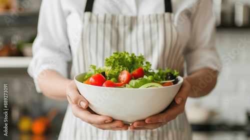 Wallpaper Mural A woman is holding a bowl of salad in her hands Torontodigital.ca