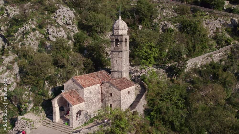 Aerial view of medieval town with church, tower, forest, and mountain, Lady of Remedy, Kotor Bay, Montenegro. Aerial view of medieval town with church, tower, forest, and mountain, Lady of Remedy, Kotor Bay, Montenegro.