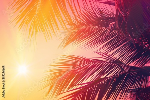 A golden tropical sunset with a dark silhouette of a coconut palm tree. Trendy vintage toned summer travel background with room for copy. Retro style creative design concept. Open composition.