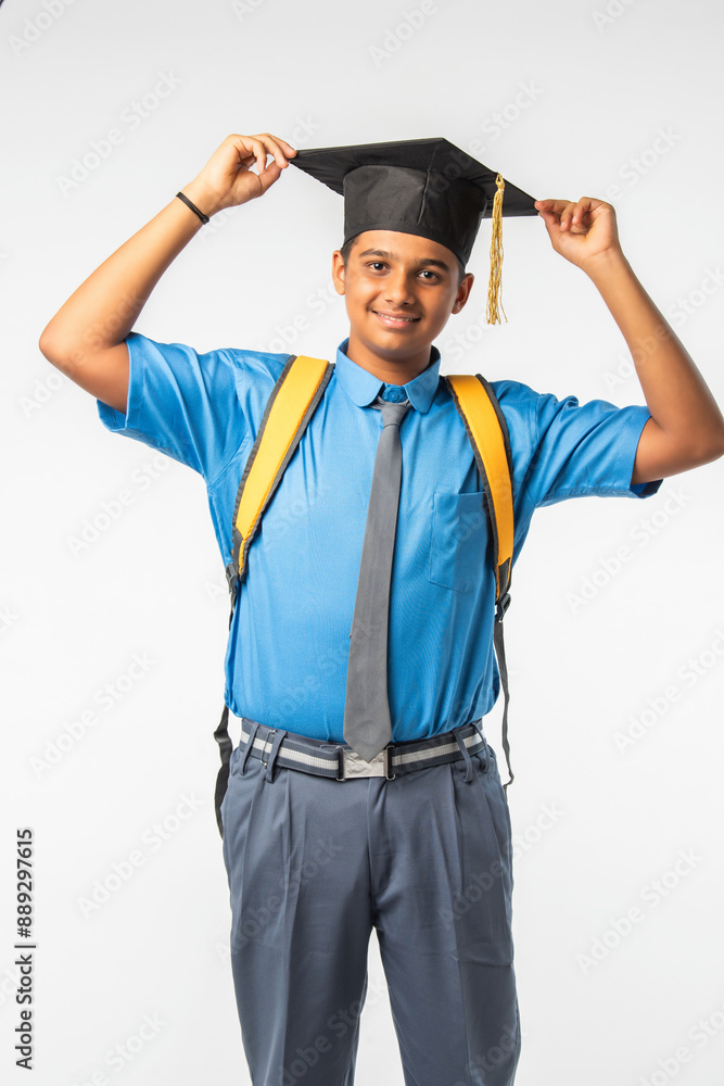 Indian Asian student, school boy in uniform with graduation cap, proudly displaying certificate roll