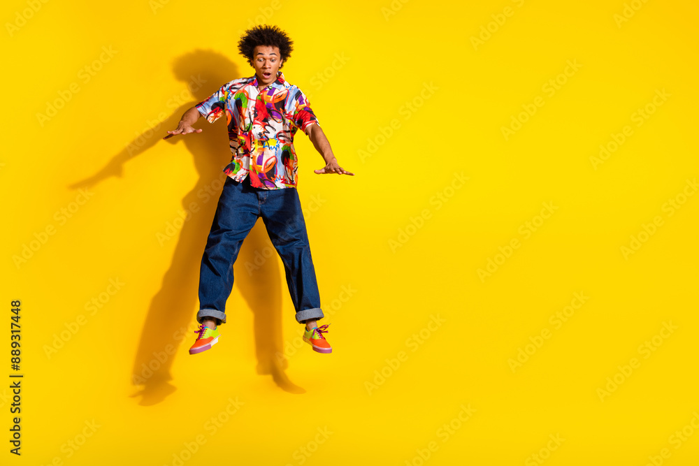 Full body portrait of nice funky young man jump fall empty space wear shirt isolated on vibrant yellow color background Full body portrait of nice funky young man jump fall empty space wear shirt isolated on vibrant yellow color background