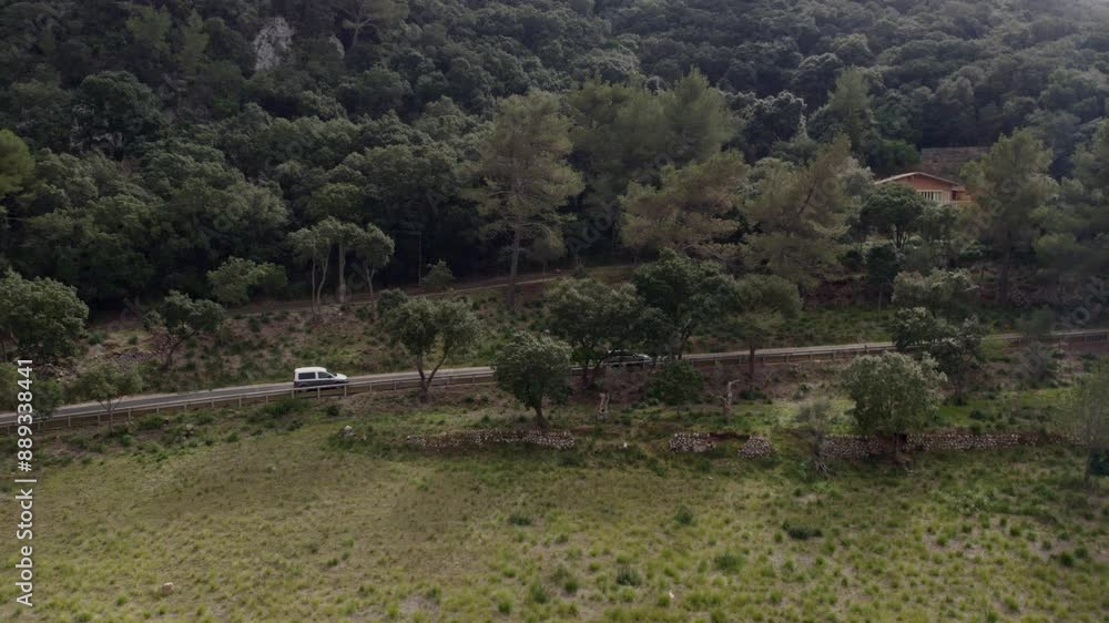Aerial view of scenic countryside with road, trees, car, and house, Mallorca, Spain. Aerial view of scenic countryside with road, trees, car, and house, Mallorca, Spain.