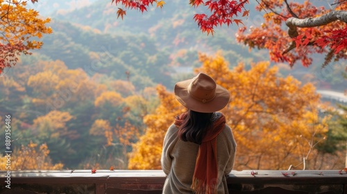 woman crossing a wooden bridge surrounded by forest in autumn photo